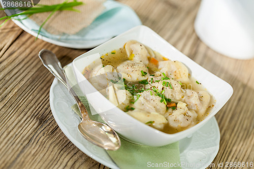 Image of Dish of savory pork tortellini in broth pelmeni russian