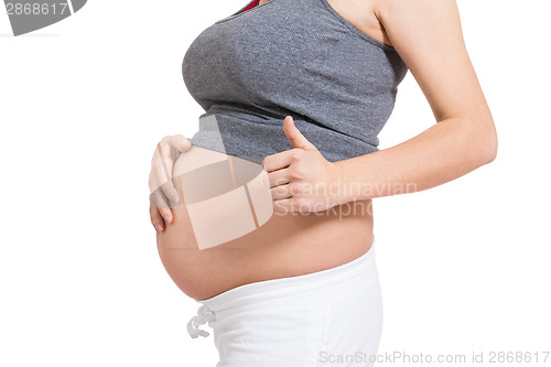 Image of Pregnant woman giving a thumbs up gesture