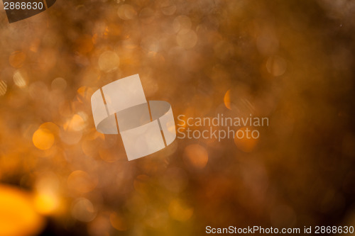 Image of Warm gold and red Christmas candlelight background