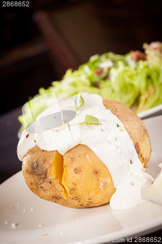 Image of Baked jacket potato with sour cream sauce