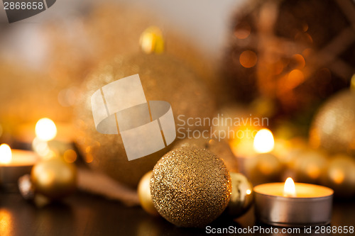 Image of Warm gold and red Christmas candlelight background