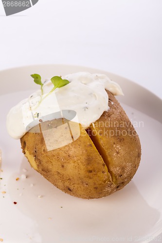 Image of Baked jacket potato with sour cream sauce