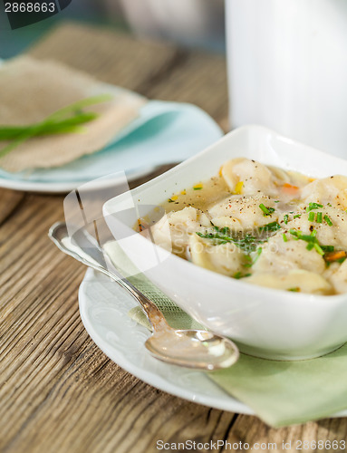 Image of Dish of savory pork tortellini in broth pelmeni russian