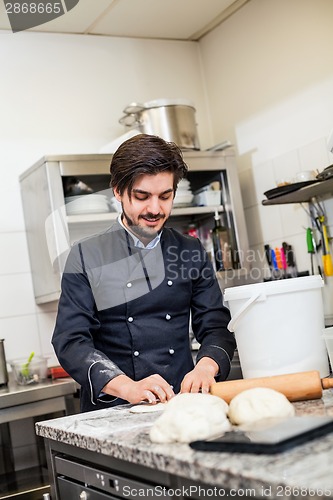 Image of Chef tossing dough while making pastries