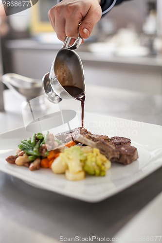 Image of Chef plating up food in a restaurant