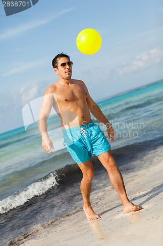 Image of Mature man kicking ball