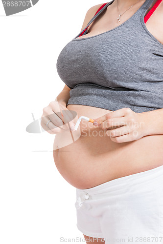 Image of Pregnant woman breaking a cigarette in two