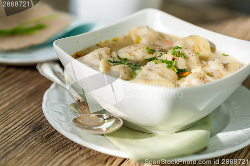 Image of Dish of savory pork tortellini in broth pelmeni russian