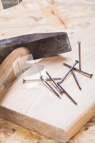 Image of Mallet with nails and planks of new wood