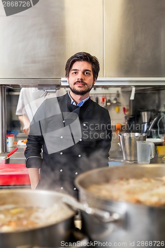 Image of Chef cooking a vegetables stir fry over a hob