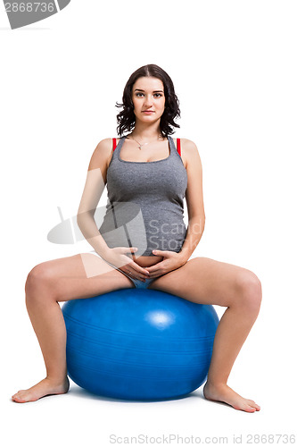 Image of Pregnant woman doing pilates exercises