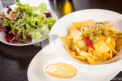 Image of Nachos with cheese sauce and chilli pepperoni