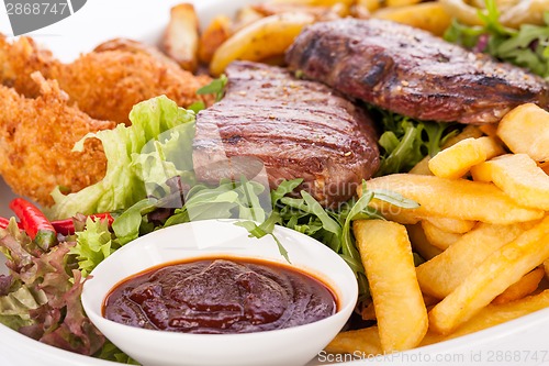 Image of Platter of mixed meats, salad and French fries