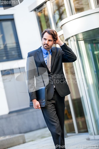 Image of Businessman standing waiting for someone