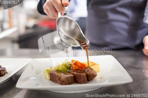 Image of Chef plating up food in a restaurant