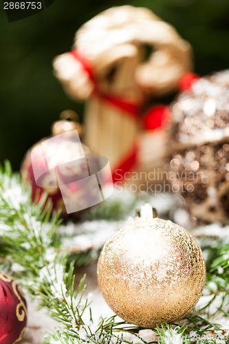 Image of Gold Christmas ornament on leaves