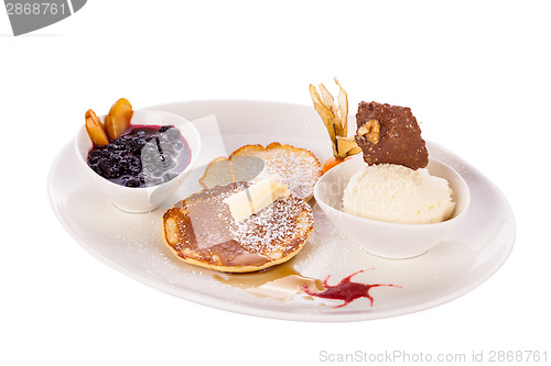 Image of tasty sweet pancakes with vanilla icecream and topping