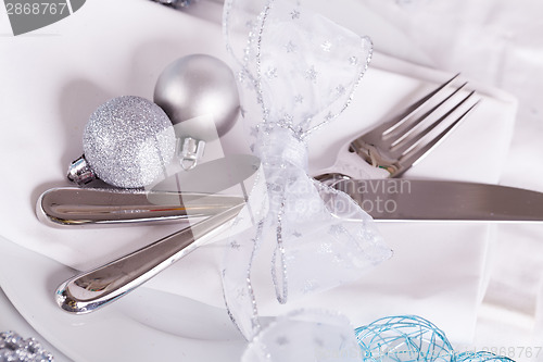 Image of Stylish blue and silver Christmas table setting