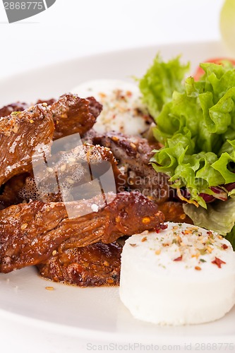 Image of grilled beef stripes fresh salad and goat cheese