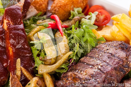 Image of Platter of mixed meats, salad and French fries