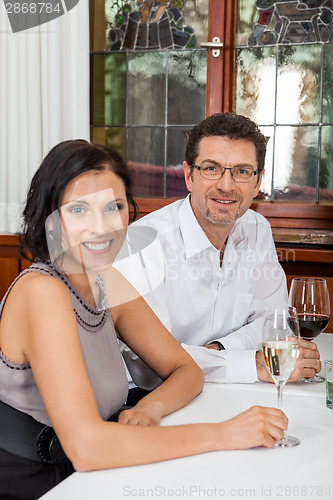 Image of Waiter happily accommodating couple