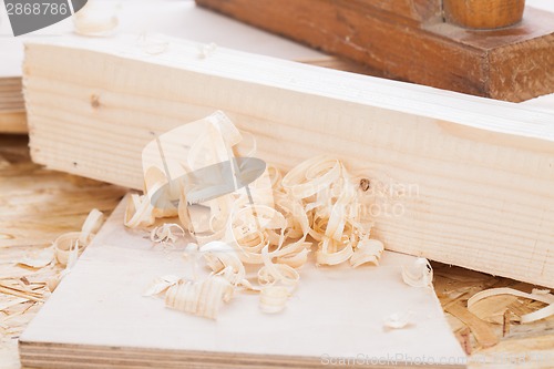 Image of Handheld wood plane with wood shavings