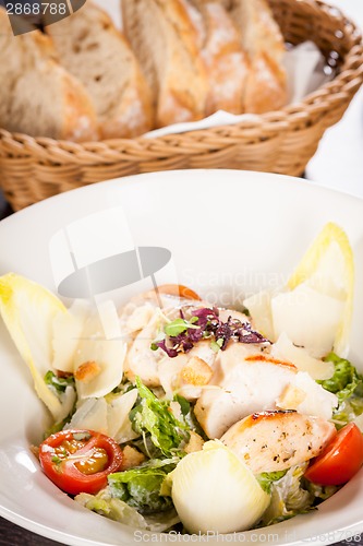 Image of tasty fresh caesar salad with grilled chicken and parmesan 