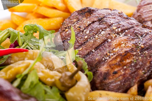 Image of Platter of mixed meats, salad and French fries