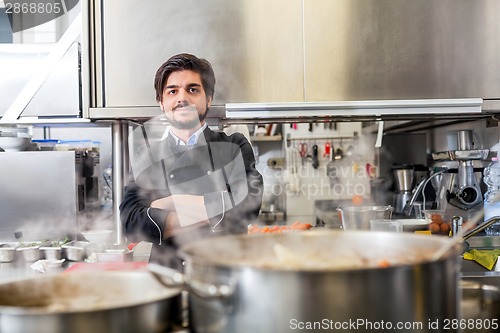 Image of Chef cooking a vegetables stir fry over a hob