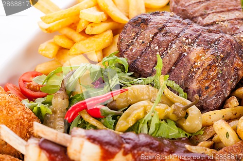 Image of Platter of mixed meats, salad and French fries