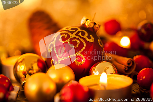 Image of Warm gold and red Christmas candlelight background