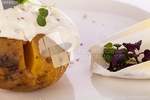 Image of Baked jacket potato with sour cream sauce