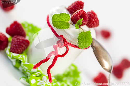 Image of Raspberries and yoghurt or clotted cream