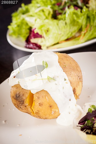 Image of Baked jacket potato with sour cream sauce