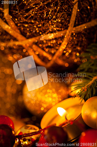 Image of Warm gold and red Christmas candlelight background