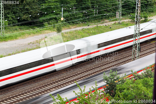 Image of Fast moving train with red stripe