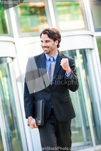 Image of Motivated businessman punching the air