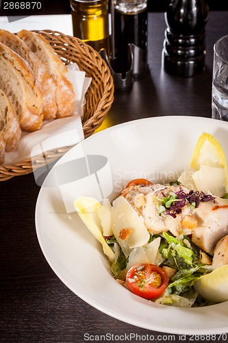 Image of tasty fresh caesar salad with grilled chicken and parmesan 