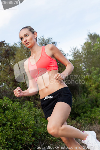 Image of Fit young woman jogging