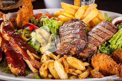 Image of Platter of mixed meats, salad and French fries