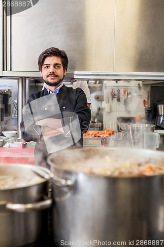 Image of Chef cooking a vegetables stir fry over a hob