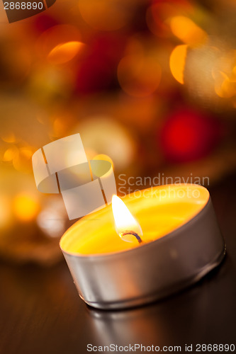 Image of Warm gold and red Christmas candlelight background