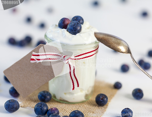 Image of Jar of clotted cream or yogurt with blueberries