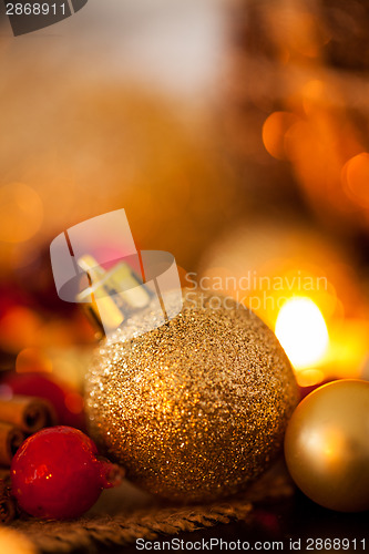 Image of Warm gold and red Christmas candlelight background