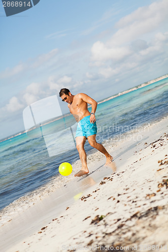 Image of Mature man kicking ball