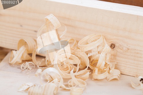 Image of Handheld wood plane with wood shavings