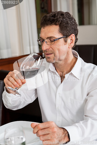 Image of Waiter happily accommodating couple