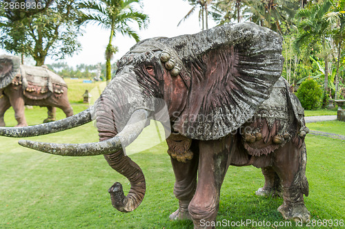 Image of Elephant statue standing on a lawn at a park