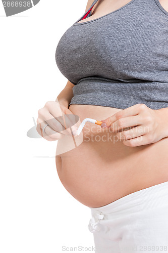 Image of Pregnant woman breaking a cigarette in two