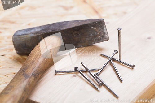 Image of Mallet with nails and planks of new wood